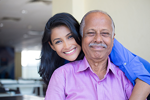Caregiver woman smiling with elderly man