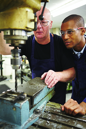 two men working with a machine