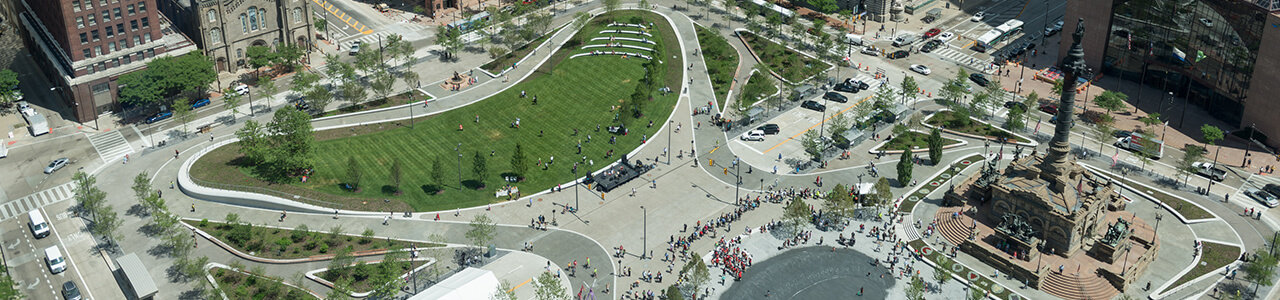 aerial view of grassy park in the middle of a city