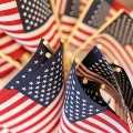 AcloseupviewofabunchofsmallAmericanflagsonsticks