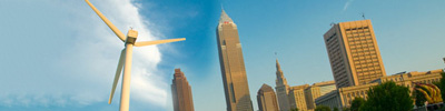 A wind turbine with downtown Cleveland buildings in the background.