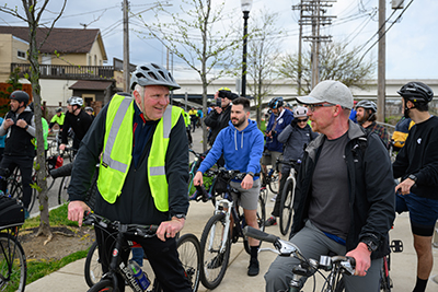 Executive, Chris Ronayne riding bike with Cuyahoga County citizens