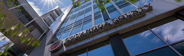 The exterior of an office building with the words Cuyahoga County and a logo on it.