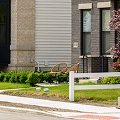 Twomodernlookinghousingbuildingswithsmallyardsonanemptystreet