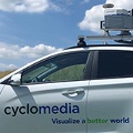 AwhitesedancarwithCyclomediaonthesideandacameramountedtothetop