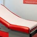 Aredupholsteredexaminationtableinanemptydoctorsoffice