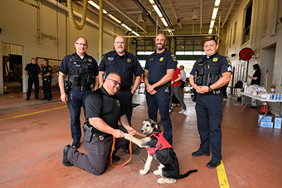 4 Police officers standing behind a K9 officer and his K9