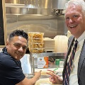 TwomenpointingtoastickerthatsaysCuyahogaCountyandsmallbusinesses