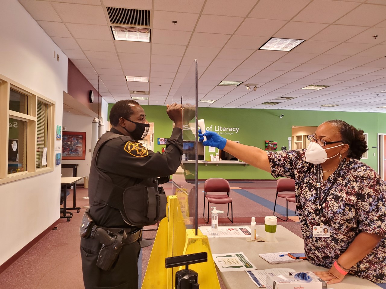 A police officer and a nurse interact. 
