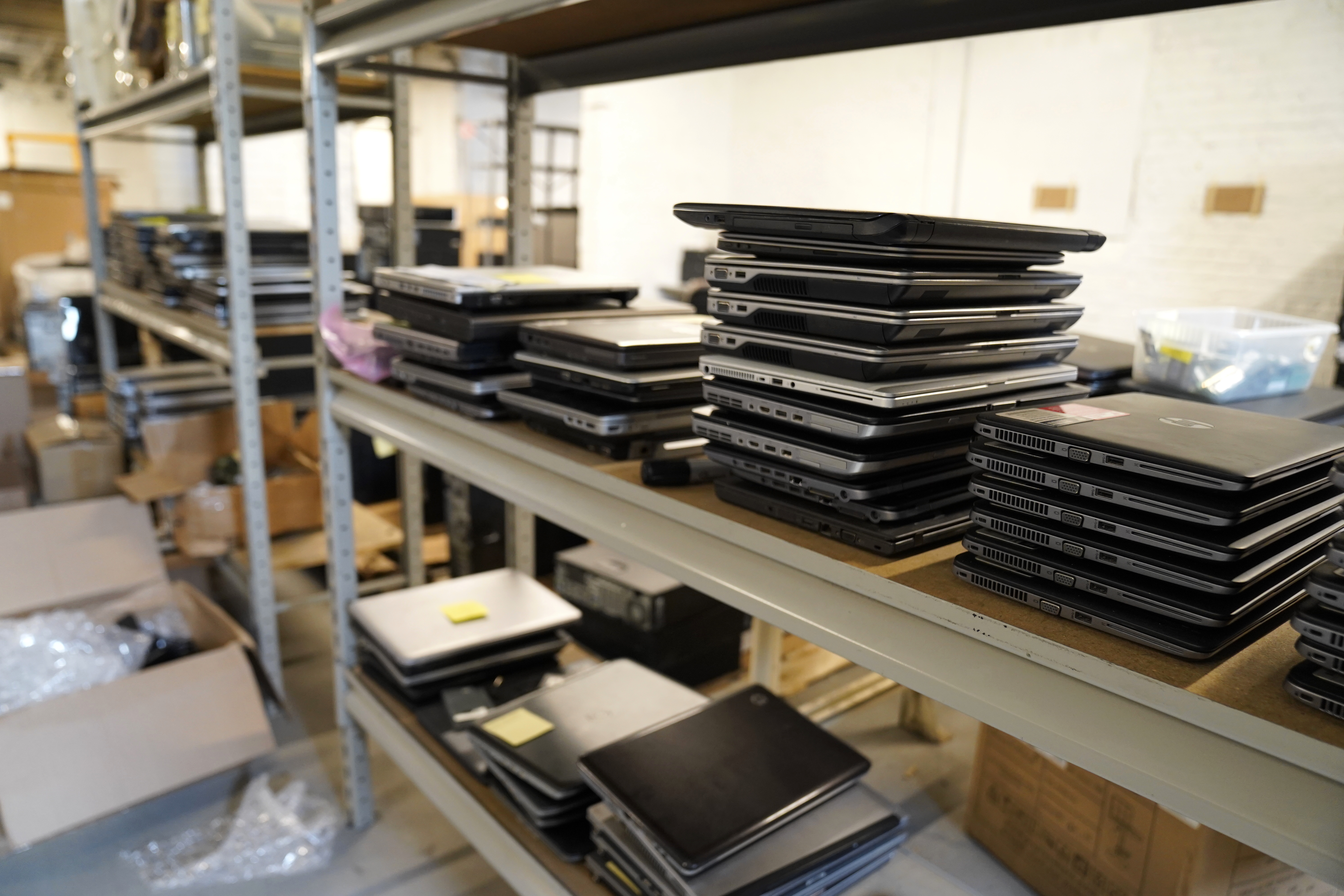 Stack of computers on a shelf