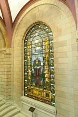 stained glass window of man holding a book