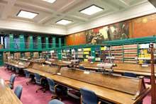 wooden desks and chairs in library