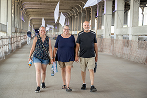 three people taking touring the Veterans Memorial Bridge
