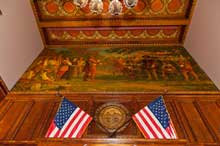 Painting of Rogers Rangers above American flags painting on wall and two American flags