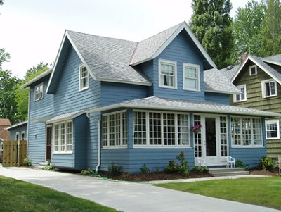 a blue house with a front yard