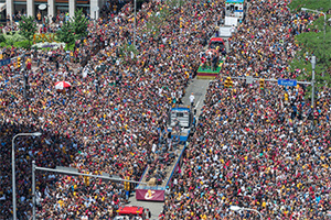large group of people outside celebrating the Cavs