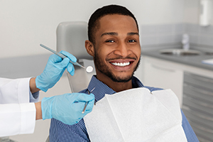 Patient in dental chair smiling