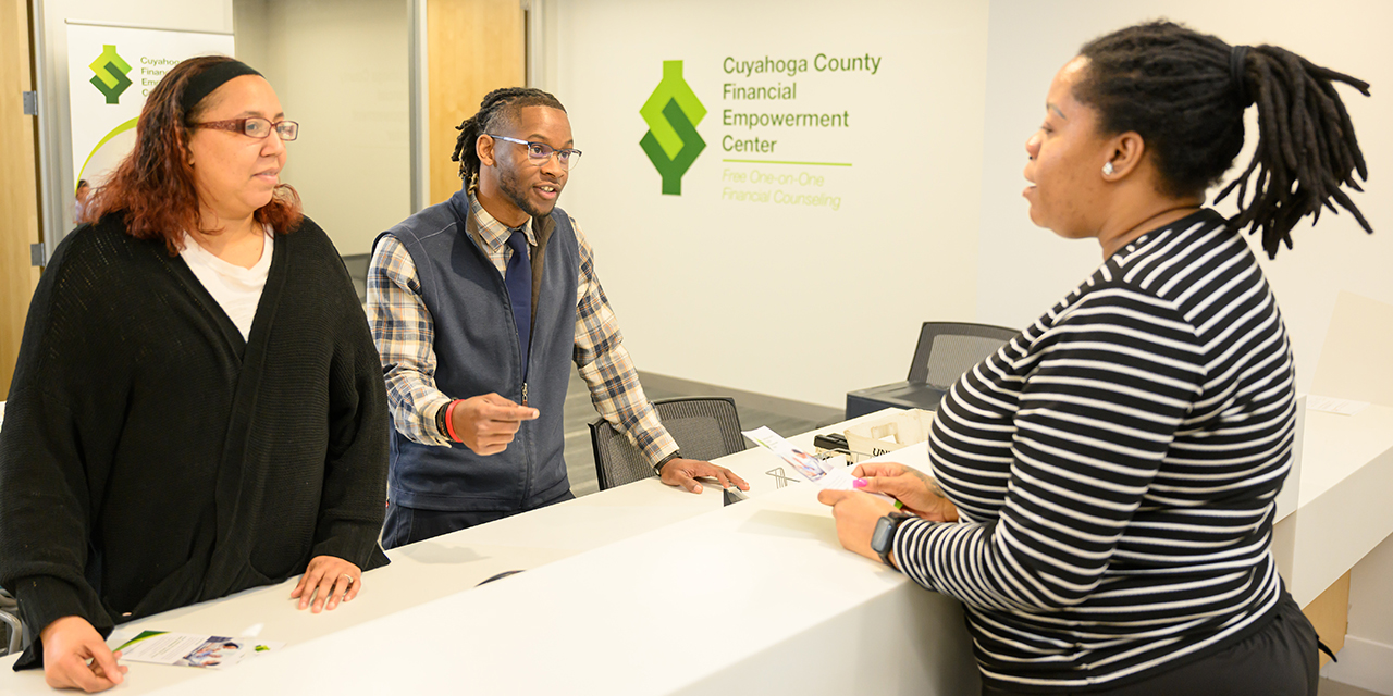 A resident receives assistance from County employees at a service counter.