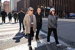 group of people smiling and waling outside