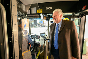 Cuyahoga County Executive Chris Ronayne standing in an RTA bus