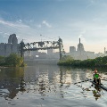 ApersonrowingasinglescullontheCuyahogaRiverwiththeClevelandskylineandtheMainAvenueBridgeinthebackgroundatsunriseorsunset