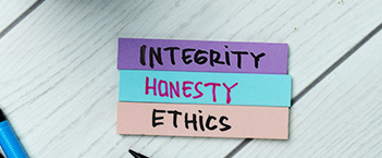 strips of paper that say Integrity, Honesty, Ethics