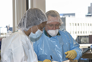 Forensic Pathologists doing an examination