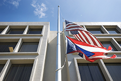 exterior of the Medical Examiner Building with flags waving