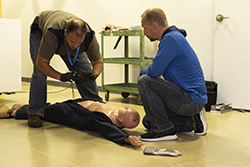 person giving medical training on a dummy