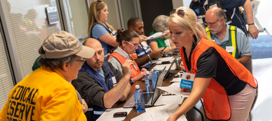 A group of emergency management staff organizing at a central location.