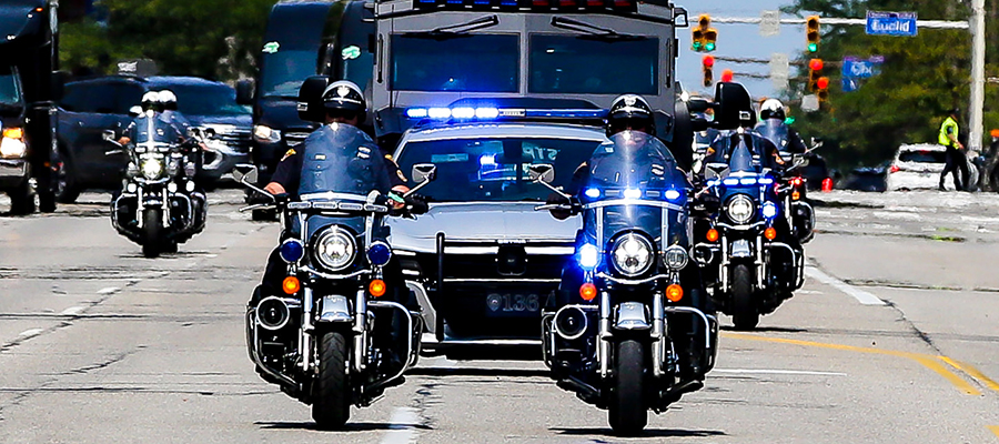 A group of police officers riding motorcycles in a memorial parade.