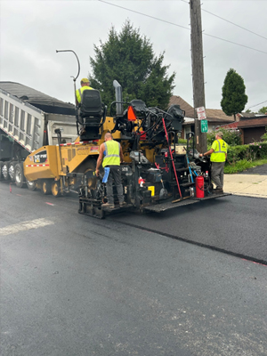 Construction truck with 2 men on back