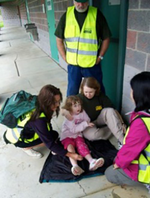 CERT member giving aid to a child