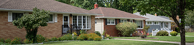 exterior of three houses in a neighborhood