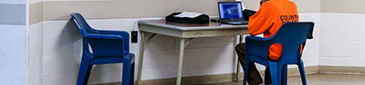 an inmate sitting at a table for visitation