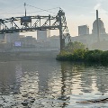 twopeoplekayakingontheCuyahogaRiverwithdowntownClevelandinthebackground