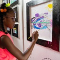 childpaintingonawallwithablackframearoundthepainting