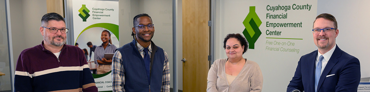 group of people in an office with Financial Empowerment Center sign behind them