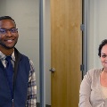 groupofpeopleinanofficewithFinancialEmpowermentCentersignbehindthem